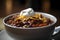 A hearty serving of beef chili, loaded with beans and vegetables, and topped with melted cheese. 